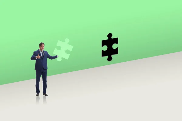 Businessman putting missing jigsaw puzzle piece — Stock Photo, Image