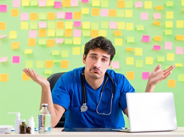 Young doctor with many reminders and urgent work — Stock Photo, Image