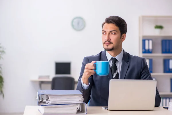 Joven empleado masculino bebiendo café durante el descanso —  Fotos de Stock