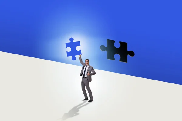Businessman putting missing jigsaw puzzle piece — Stock Photo, Image