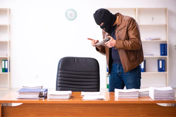 Young man in balaclava stealing information from the office — Stock Photo, Image