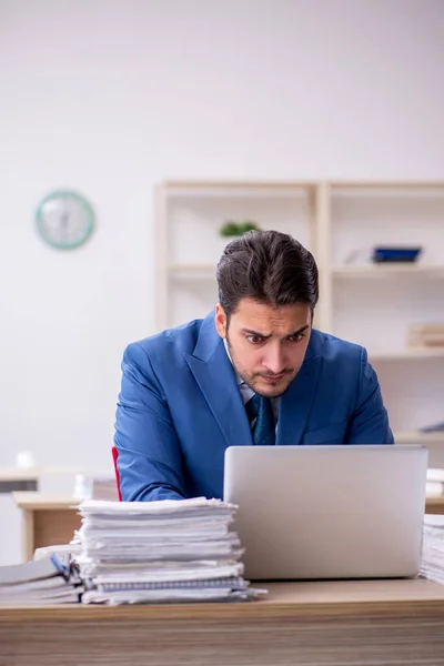 Young businessman employee and too much work in the office — Stock Photo, Image