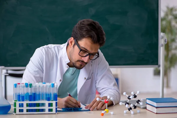 Młody chemik przed tablicą — Zdjęcie stockowe