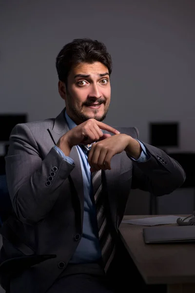 Young male employee working late in the office — Stock Photo, Image