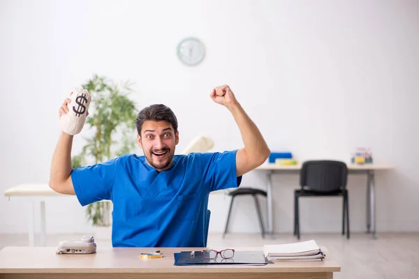 Young male doctor in remuneration concept — Stock Photo, Image