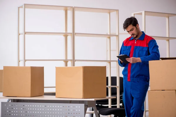 Young male contractor in movement concept at workplace