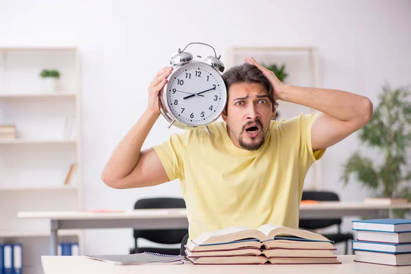 Young male student preparing for exams in time management concep — Stock Photo, Image