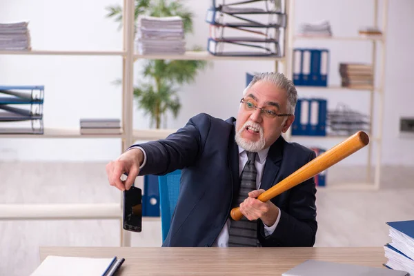 Alter männlicher Angestellter zerstört Handy mit Baseballschläger — Stockfoto