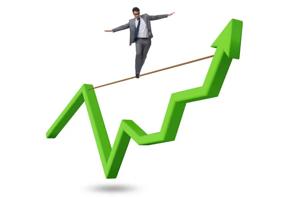 Businessman balancing on tightrope on line chart — Stock Photo, Image