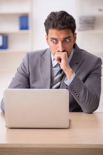 Junge männliche Angestellte unzufrieden mit exzessiver Arbeit im Büro — Stockfoto