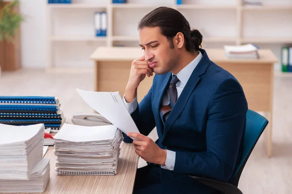 Young male employee unhappy with excessive work — Stock Photo, Image