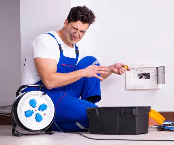 Funny Man doing electrical repairs at home