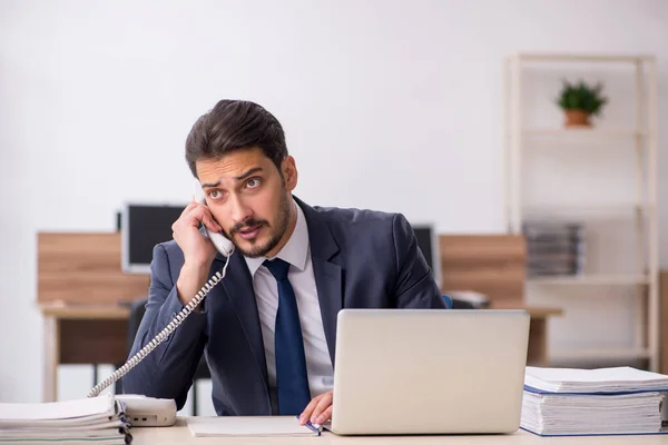 Jeune employé masculin assis sur le lieu de travail — Photo