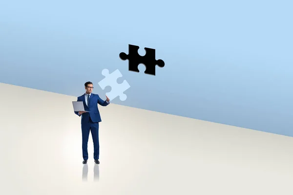 Businessman putting missing jigsaw puzzle piece — Stock Photo, Image