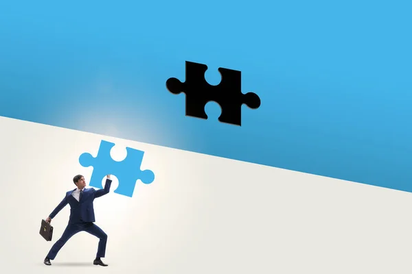 Businessman putting missing jigsaw puzzle piece — Stock Photo, Image