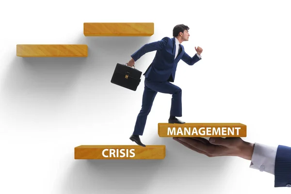 Crisis management concept with climbing businessman — Stock Photo, Image