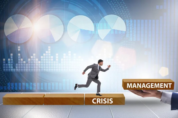 Crisis management concept with climbing businessman — Stock Photo, Image