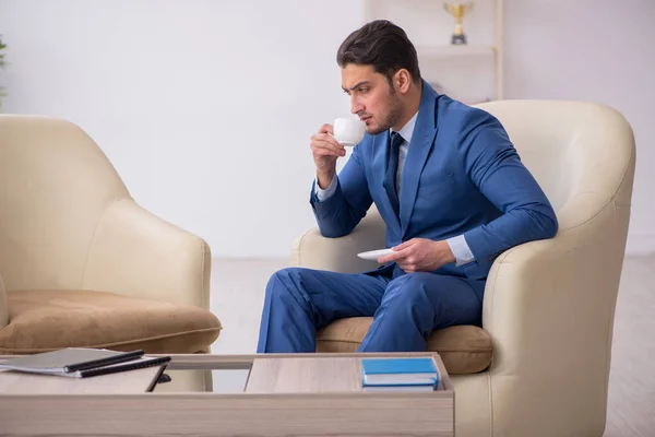 Young male employee waiting for business meeting — Stock Photo, Image