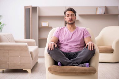 Salgın sırasında evde oturan genç adam.