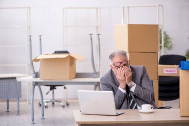 Taşınma konseptinde çalışan yaşlı bir erkek.