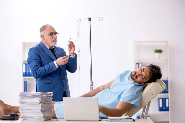 Young male employee feeling bad at workplace