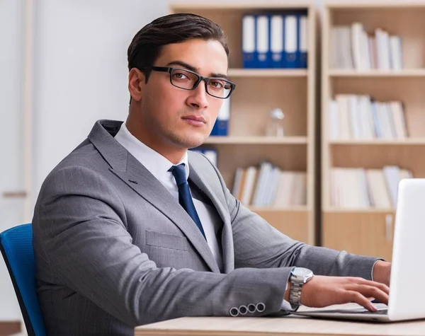 Молодой привлекательный бизнесмен работает в офисе — стоковое фото