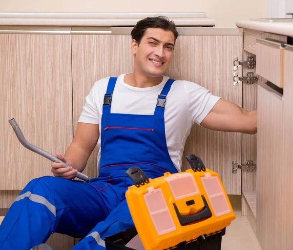 Joven reparador trabajando en la cocina — Foto de Stock