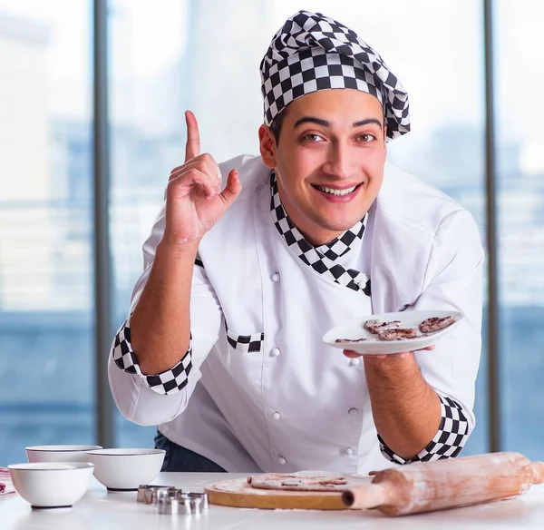 Young man cooking cookies in kitchen — Stock Photo, Image