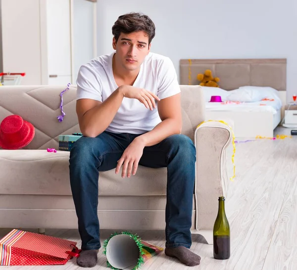 Man after heavy christmas partying at home — Stock Photo, Image