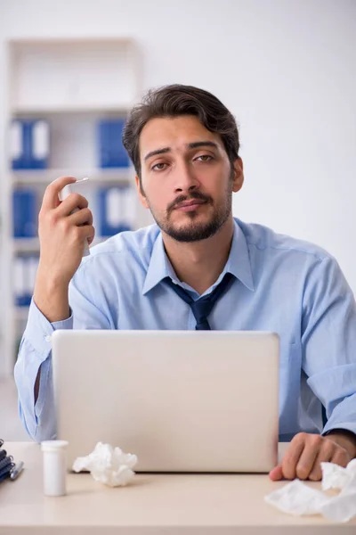 Young male employee suffering at workplace — Stock Photo, Image