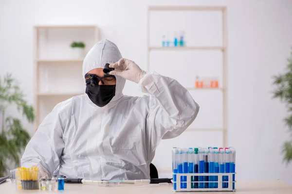 Fiatal férfi vegyész, aki a laborban dolgozik a világjárvány idején — Stock Fotó
