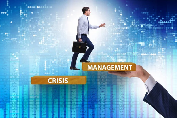 Crisis management concept with climbing businessman — Stock Photo, Image