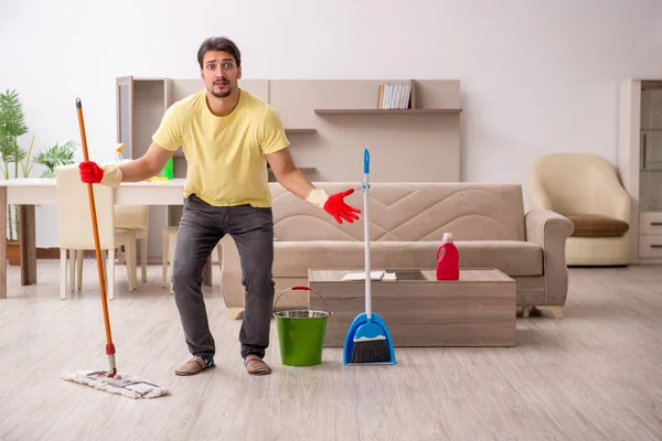 Joven contratista masculino limpiando la casa — Foto de Stock