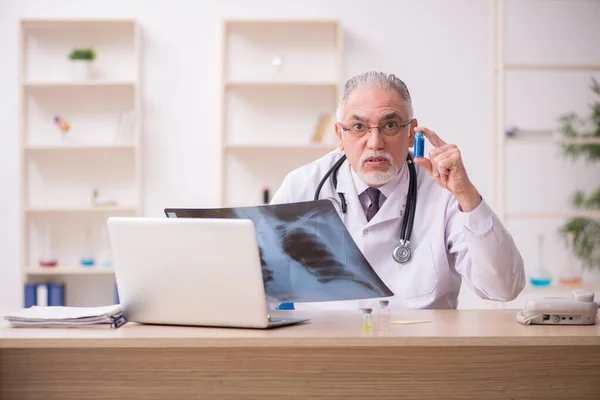 Vecchio medico radiologo maschile che lavora in clinica durante pandemi — Foto Stock