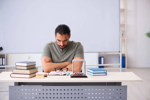 Young male student preparing for exams in the classroom — Stock Photo, Image