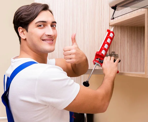 Young man assembling kitchen furniture — Stock Photo, Image