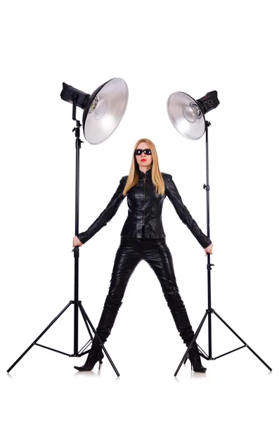 Woman in black leather dress in studio shootout — Stock Photo, Image