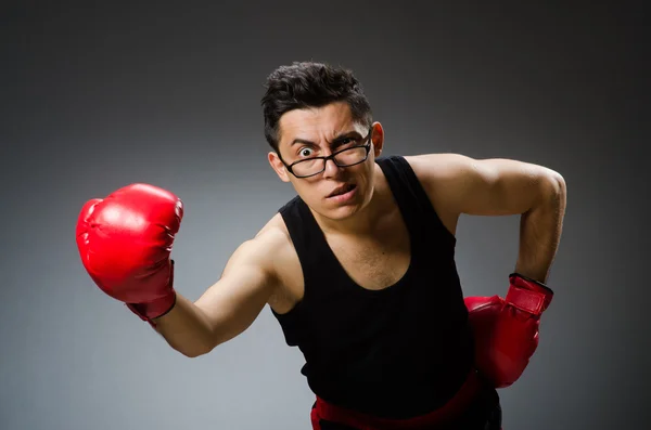 Funny boxer with red gloves against dark background — Stock Photo, Image