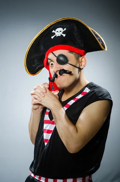 Funny pirate in the dark studio — Stock Photo, Image