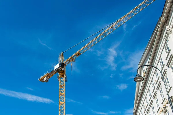 Grue de construction à côté du bâtiment — Photo