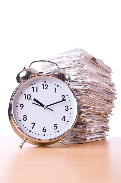 Stack of papers and clock isolated on white — Stock Photo, Image