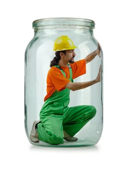 Man in coveralls imprisoned in glass jar — Stock Photo, Image