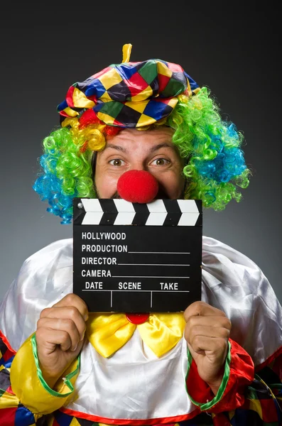 Clown with movie clapper board — Stock Photo, Image