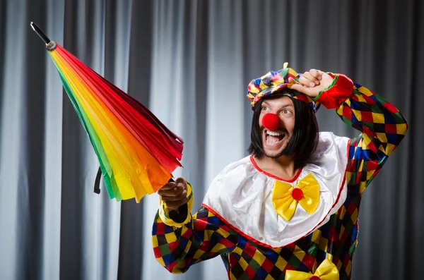 Funny clown with colourful umbrella — Stock Photo, Image