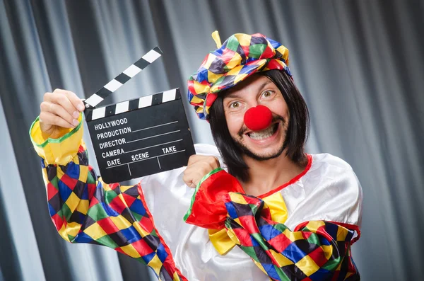 Clown with movie clapper board — Stock Photo, Image