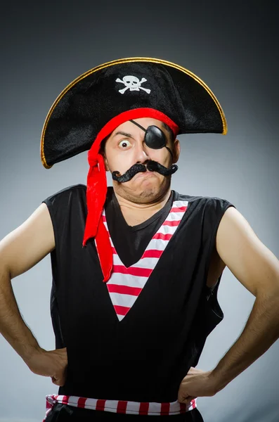 Funny pirate in the dark studio — Stock Photo, Image