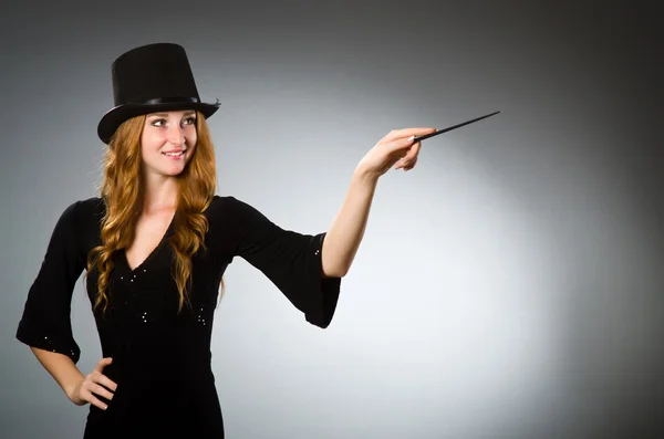 Woman magician doing her tricks with wand — Stock Photo, Image