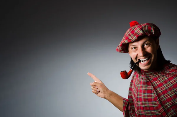 Funny scotsman with smoking pipe — Stock Photo, Image