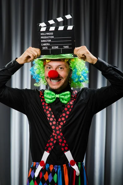 Clown with movie clapper board — Stock Photo, Image