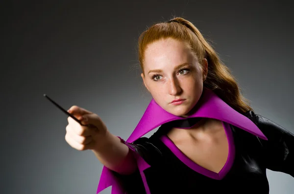 Female magician doing tricks on grey background — Stock Photo, Image